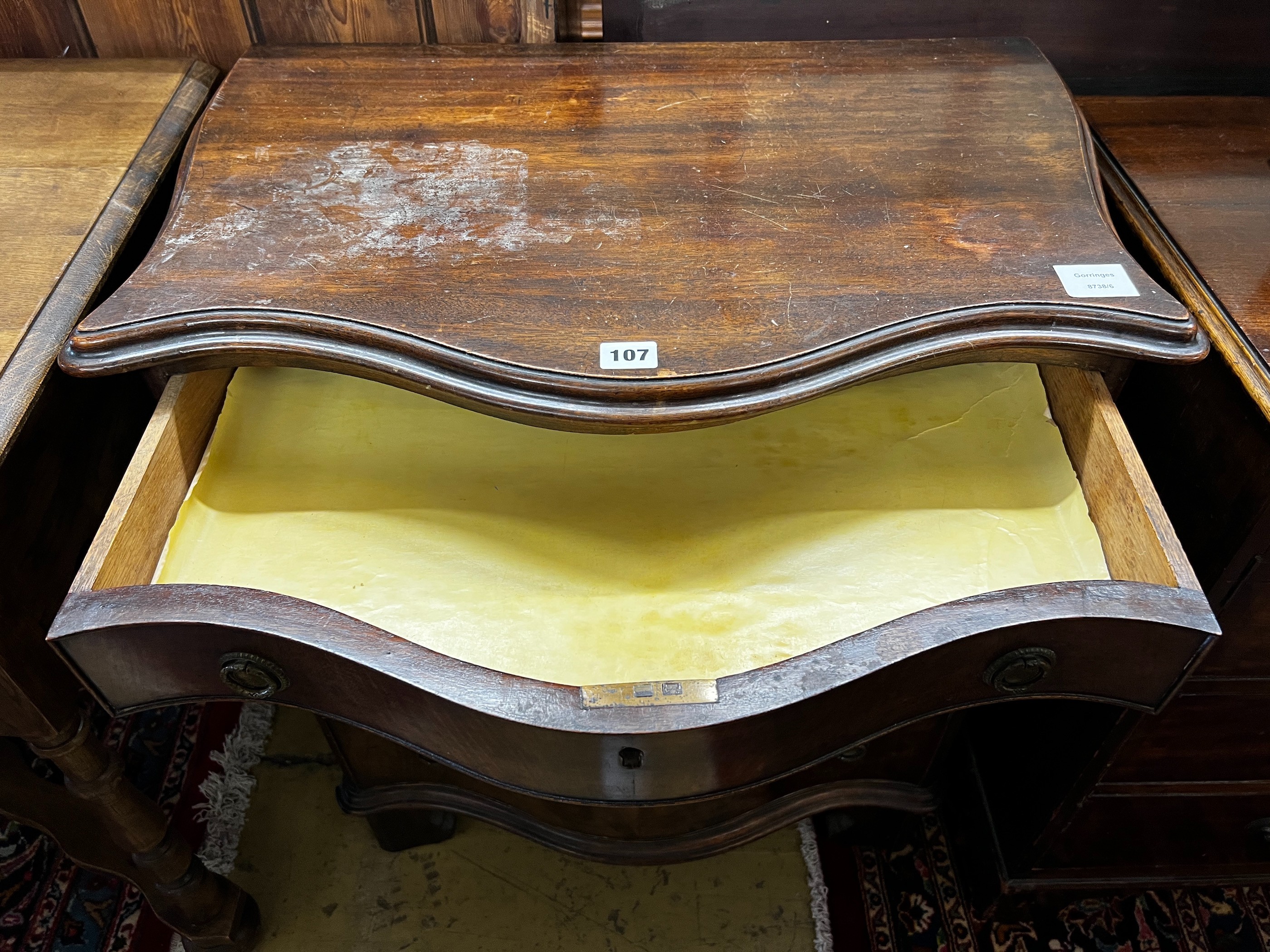 A small George III style mahogany serpentine chest of four drawers, width 65cm, depth 43cm, height 77cm